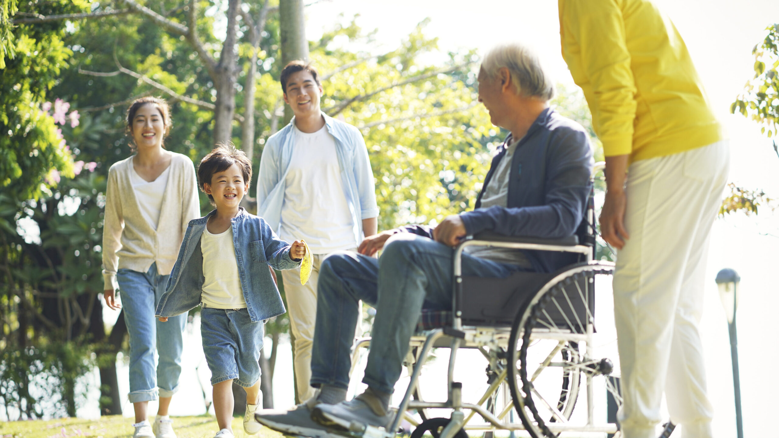 Elderly man in wheelchair with his family.
