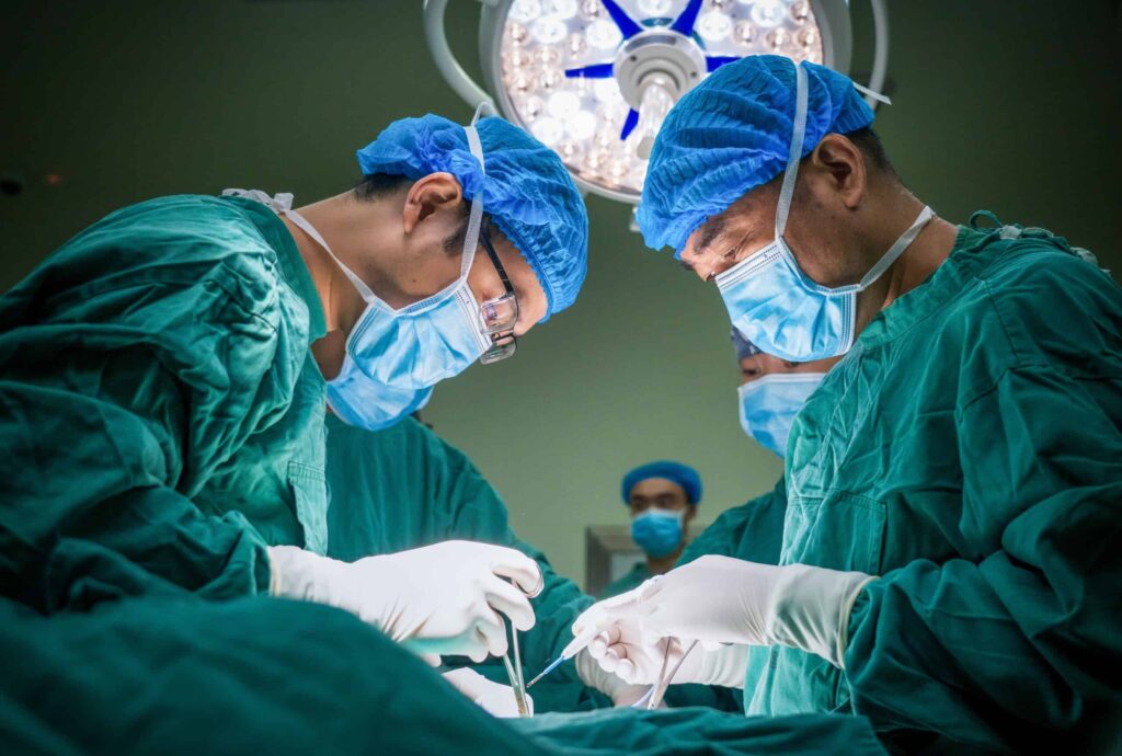 Two surgeons conducting a medical operation.