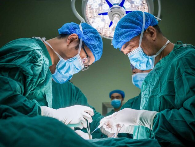 Two surgeons conducting a medical operation.